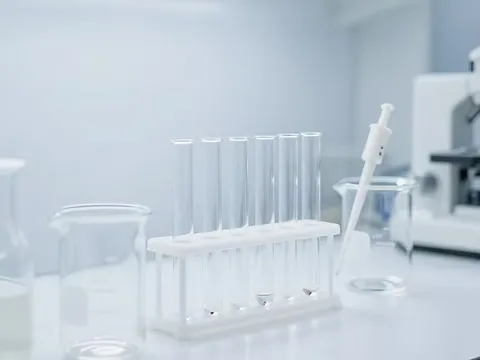 Laboratory test tubes and equipment on a workbench.